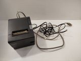 a small printer and a charger sitting on a table