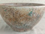 a close up of a small bowl on a table