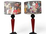 two red lamps with a black base and a red shade on them