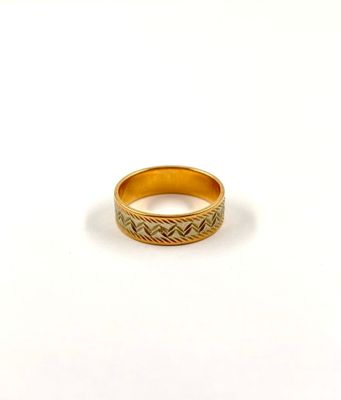 a close up of a gold ring on a white surface