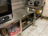 a kitchen with a stove, oven, sink, and other items on the counter