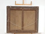 an old wooden easel with a painting on top of it