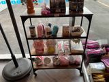 a shelf with various items on it in front of a window