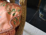 a chair that has a pillow on it in front of a fire place