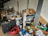 a pile of boxes and other items in a garage