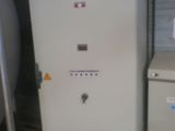 a white refrigerator sitting next to a metal tank