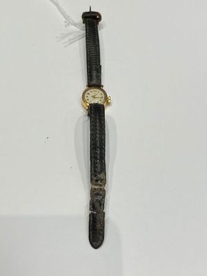 an image of a watch that is laying on a white surface