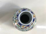 a small vase that is sitting on a white table