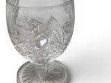 a glass cup that is sitting on top of a coaster