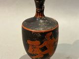 a vase with a picture of a man riding a horse
