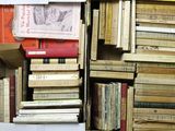 many books stacked on top of each other in a box