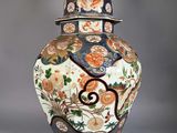 a vase with a lid that has flowers and birds on it