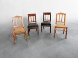 three wooden chairs sitting next to each other on a cement floor