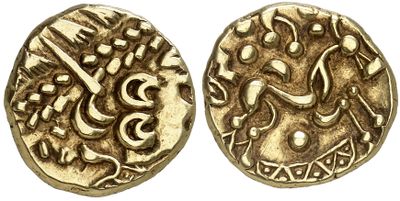 a close up of two gold coins with arabic writing on them