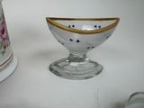 a small glass bowl with a gold rim next to a smaller glass bowl