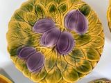 yellow and purple plates and bowls with purple flowers on them