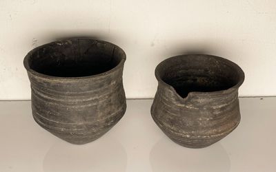 two vases that are sitting on a table