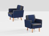 two blue chairs sitting next to each other on a white surface