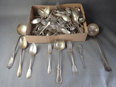 a box full of silver spoons and spoons on a table