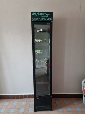 a refrigerator that has a sign on it in a room
