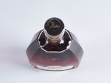 a bottle of liquor sitting on a white surface