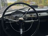dashboard of a classic car with a steering wheel and a clock