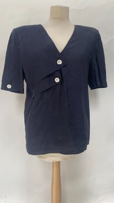the shirt is blue and has buttons on the front