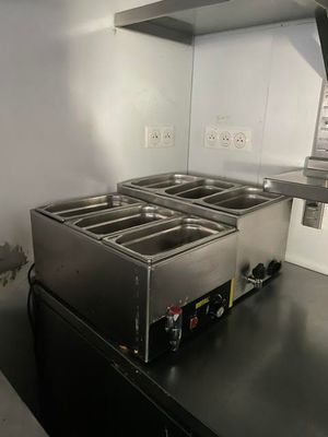 an image of a commercial kitchen with three deep fryers