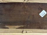 a picture of a piece of wood with a tag on it
