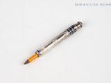 a pencil that is laying on a white surface