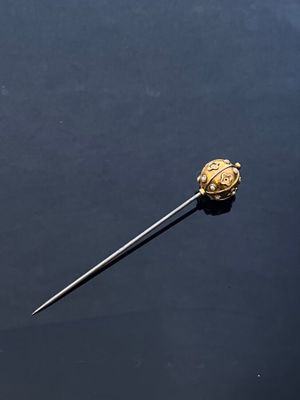 a close up of a metal object on a black surface