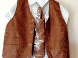 a brown vest and tie on a hanger
