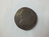 a close up of a coin on a table with a white background