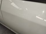 a close up of a white car with a sticker on it