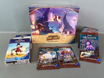 a lot of cards and a box of games on the table