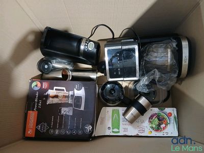 a box containing a camera, a cell phone, and other items