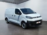 the white van is parked in a large room with white walls