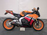 a motorcycle that is sitting on a black and white checkered floor