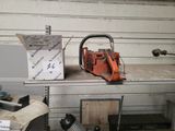 a chainsaw sitting on top of a workbench in a garage