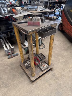 a work table with tools on it in a garage