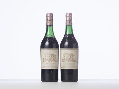 two bottles of wine sitting next to each other on a table