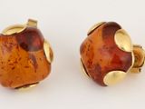 pair of yellow and brown glass stud earrings on white background