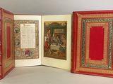 three books that are open on a table