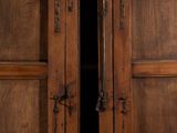 pair of antique wooden doors with iron hardware and glass panels