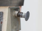 a close up of a metal object with a screw on it
