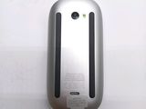 a close up of a silver mouse on a white surface
