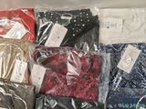 a lot of clothes that are wrapped in plastic bags