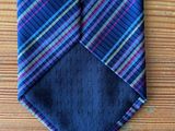 a close up of a tie on a wooden table