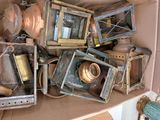 a box full of old and rusty lamps and other items