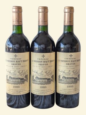 three bottles of wine sitting on top of a table next to each other